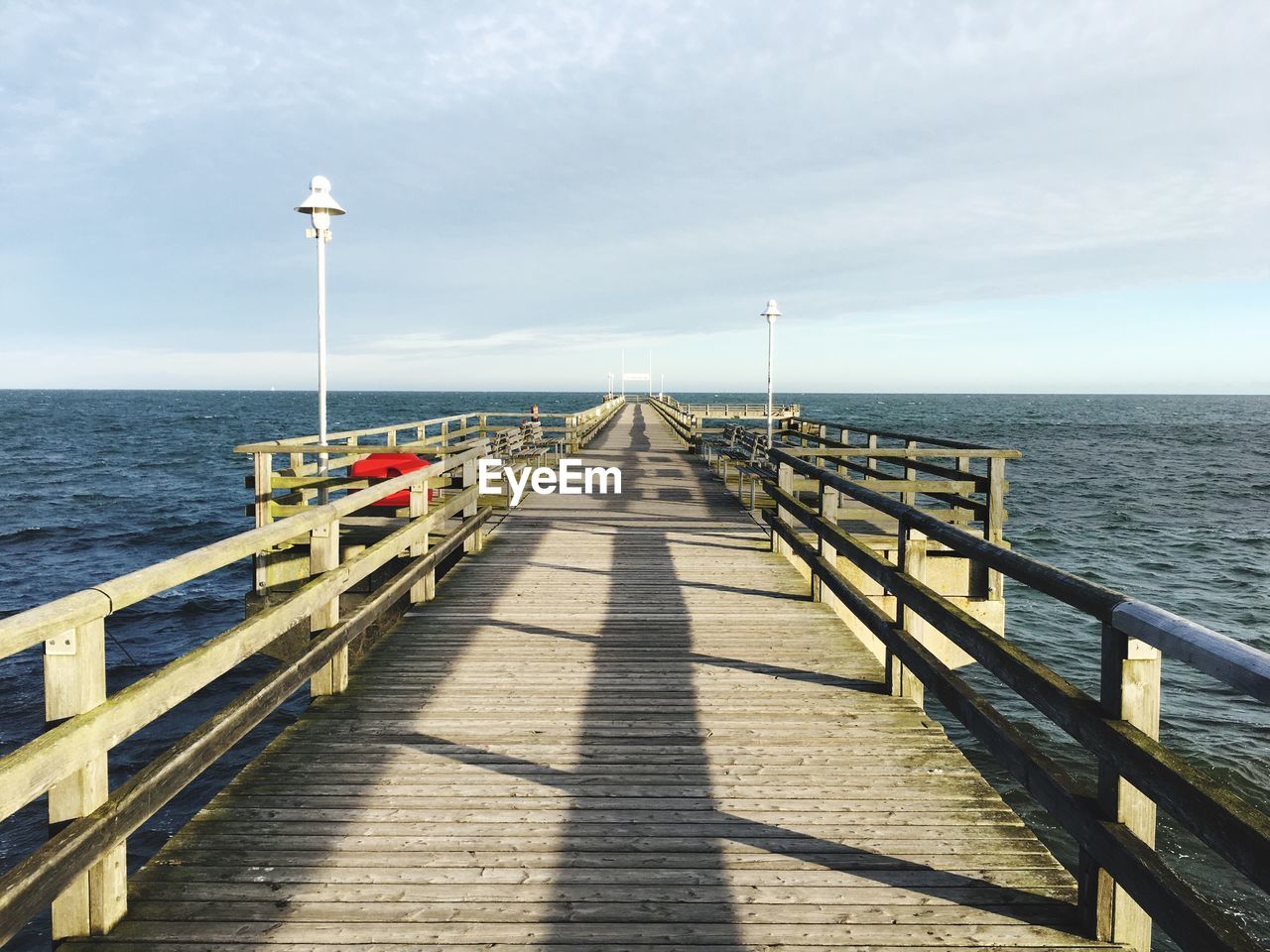 Pier over sea against sky