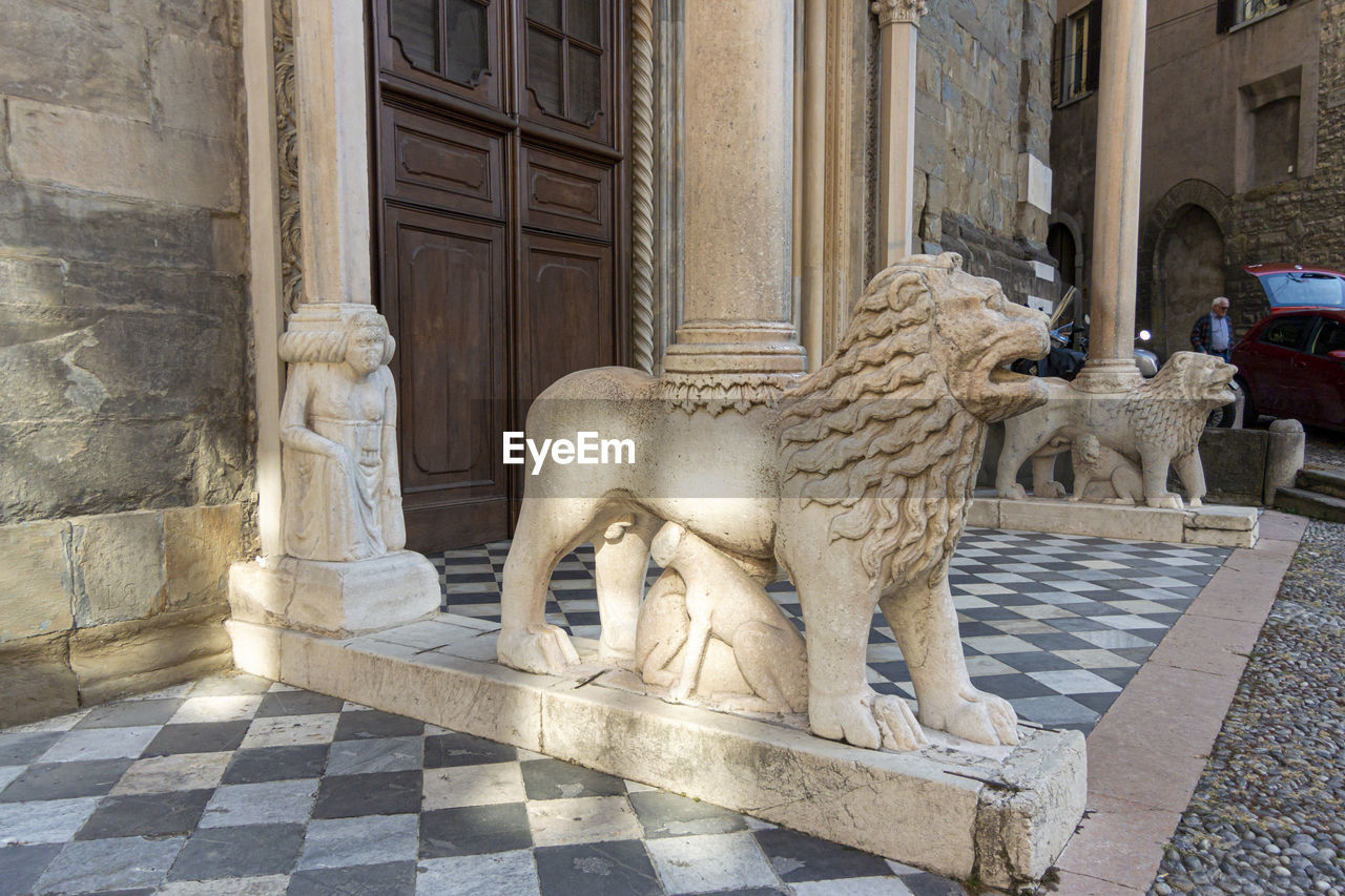 Marble lions at the entrance to santa maria maggiore, in the ancient city of bergamo, italy