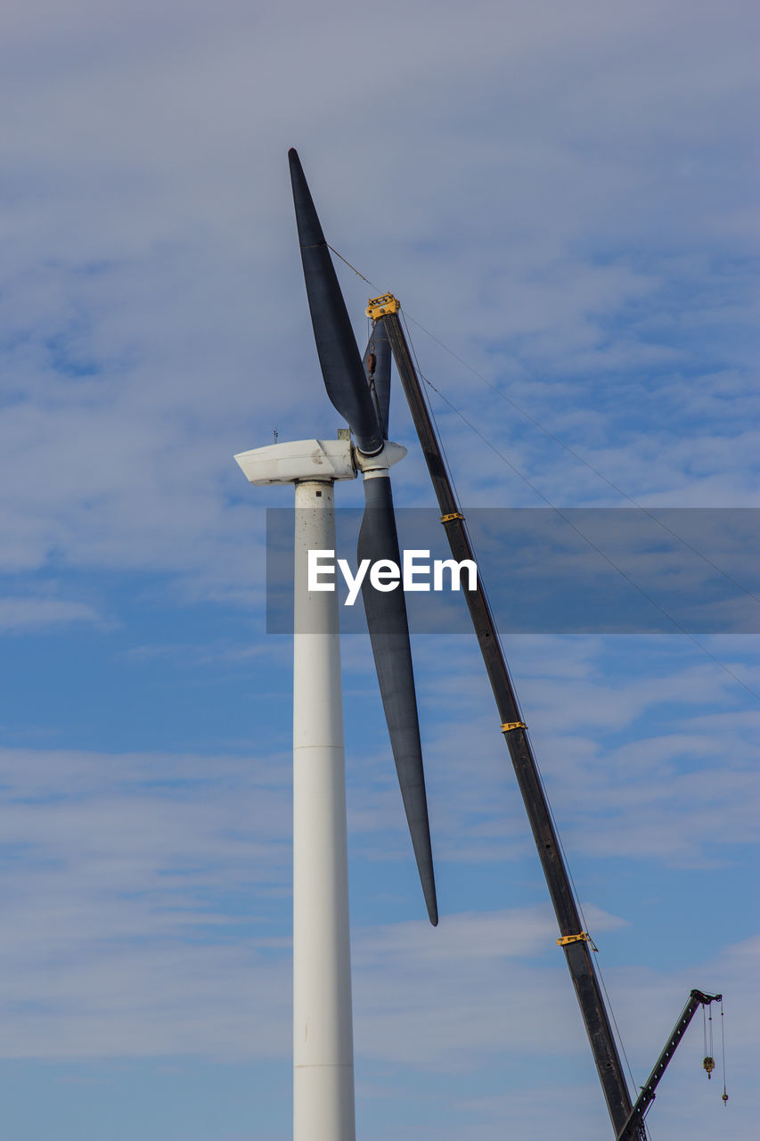 Low angle view of wind turbine against sky