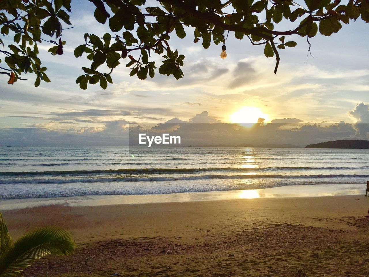 SCENIC VIEW OF BEACH AGAINST DRAMATIC SKY