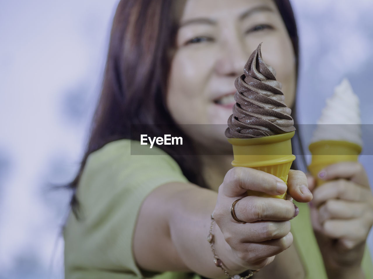 midsection of woman holding ice cream cone