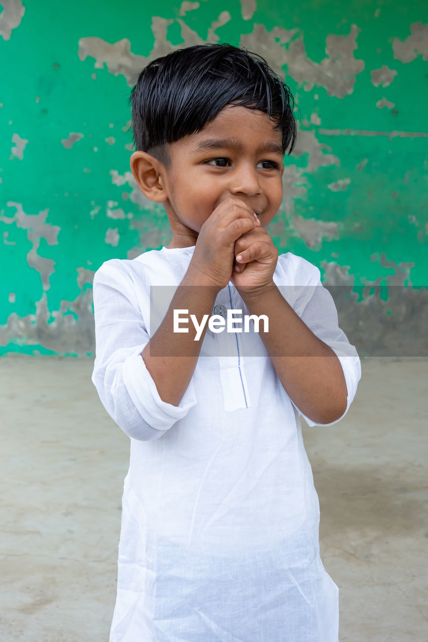 PORTRAIT OF CUTE BOY LOOKING AT CAMERA