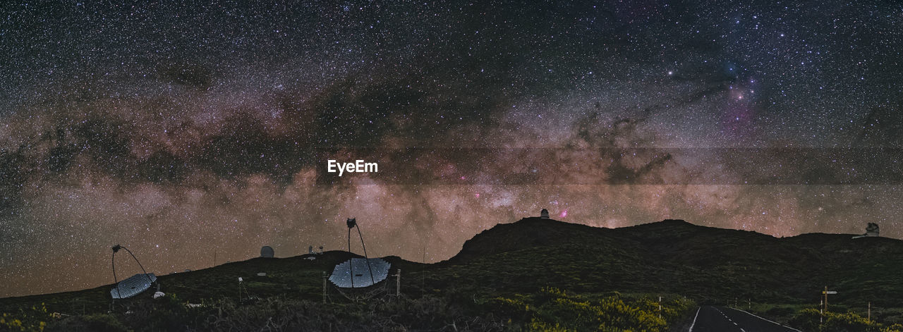 Scenic view of mountains against sky at night