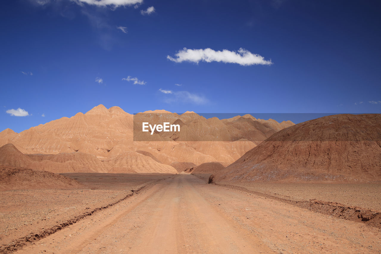 scenic view of desert against clear blue sky