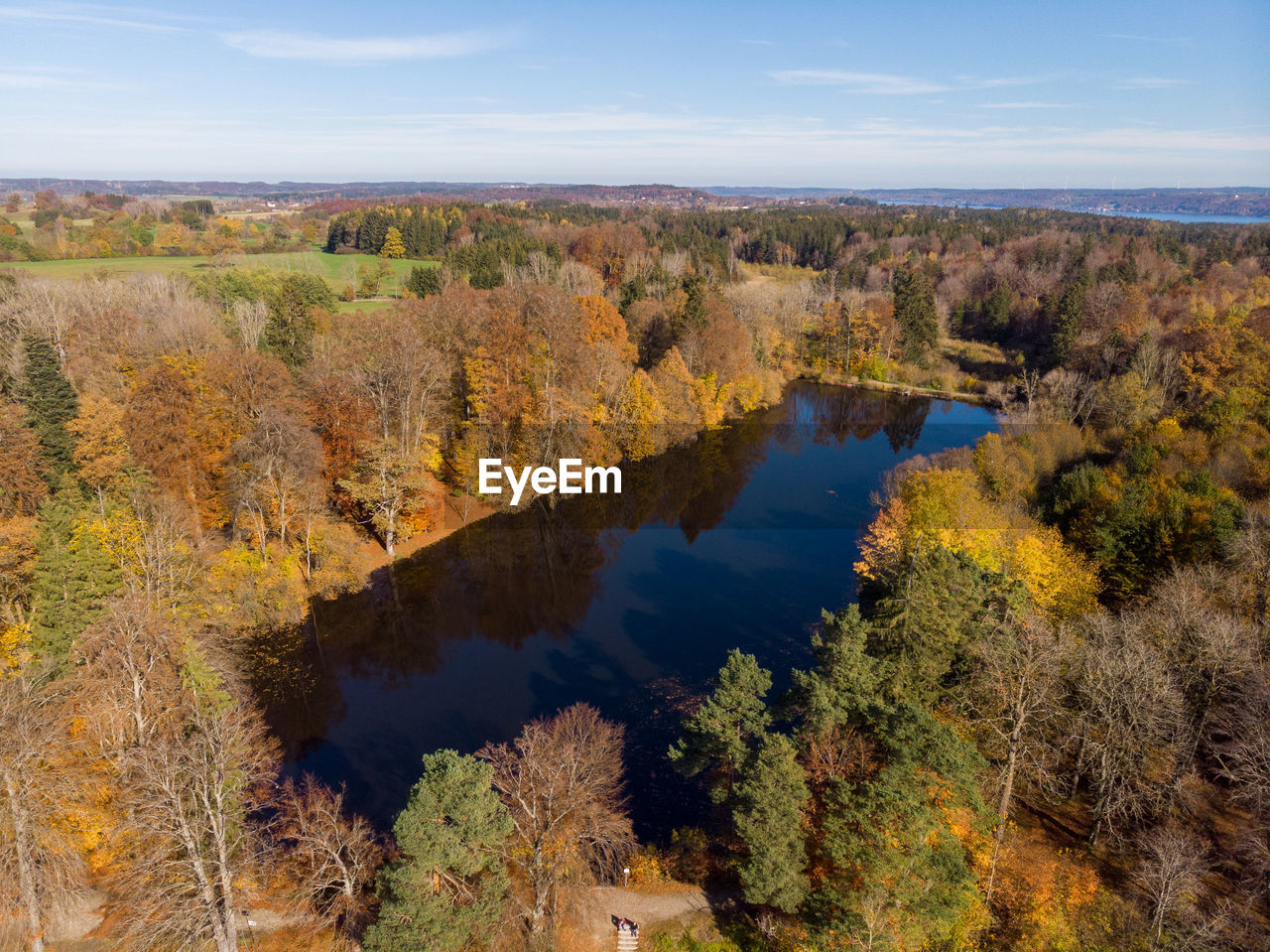 High angle view of trees by lake against sky