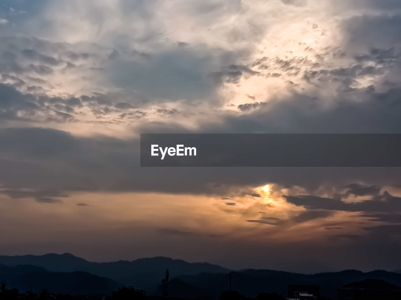 LOW ANGLE VIEW OF SILHOUETTE MOUNTAINS AGAINST DRAMATIC SKY