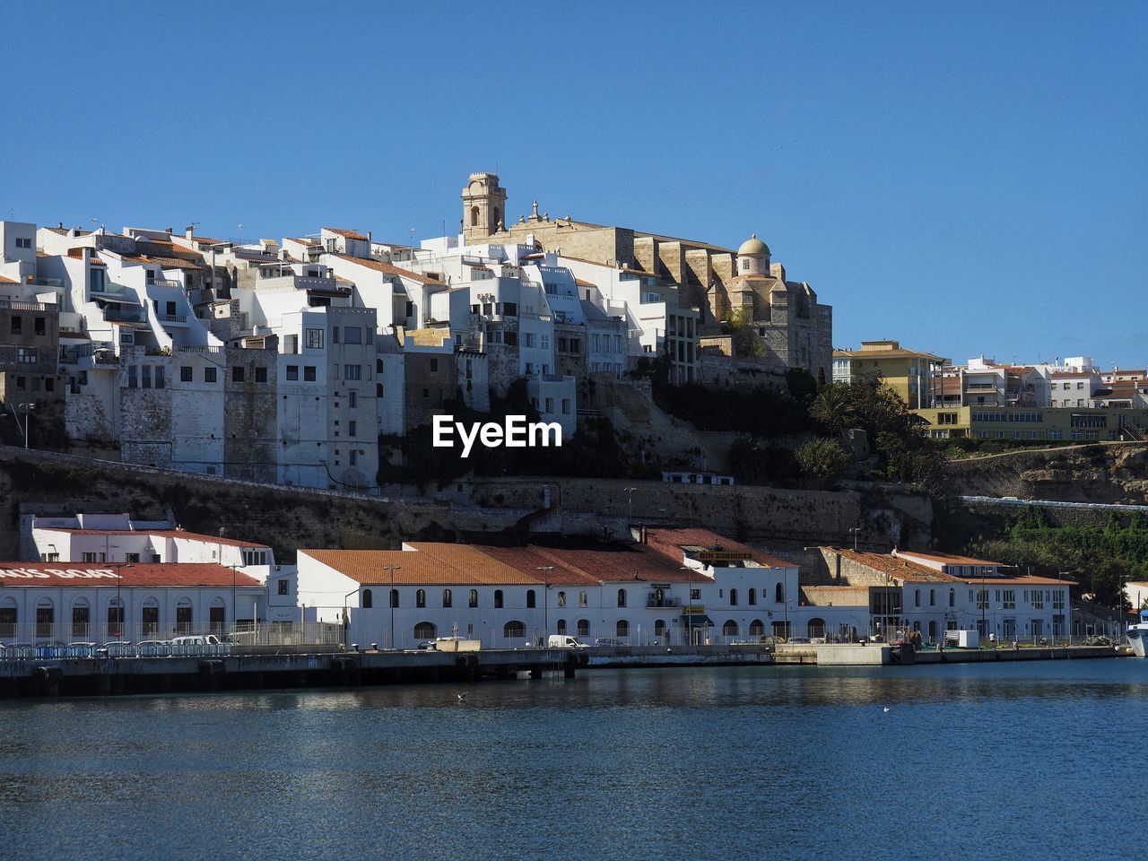 Skyline of mahón against clear blue sky