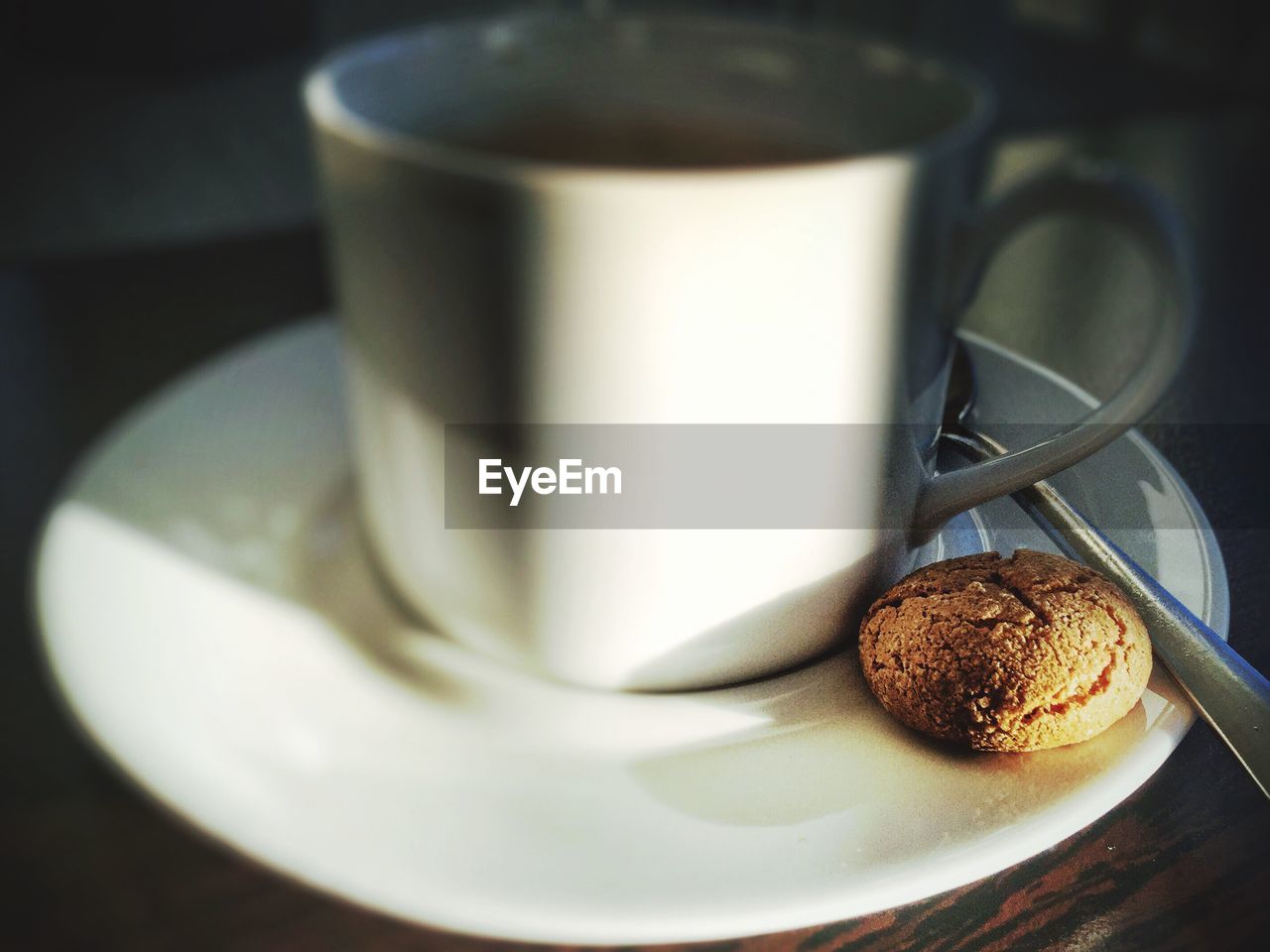 Close-up of coffee and cookie on table