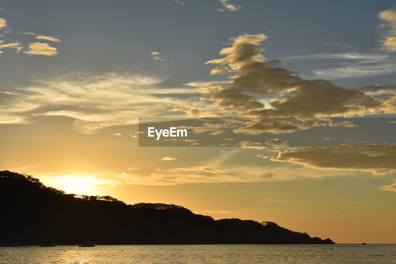 Scenic view of silhouette against sky at sunset