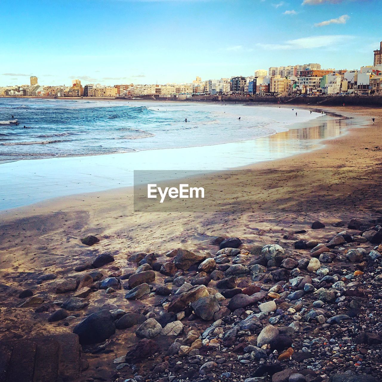 VIEW OF SEA WITH BUILDINGS IN BACKGROUND