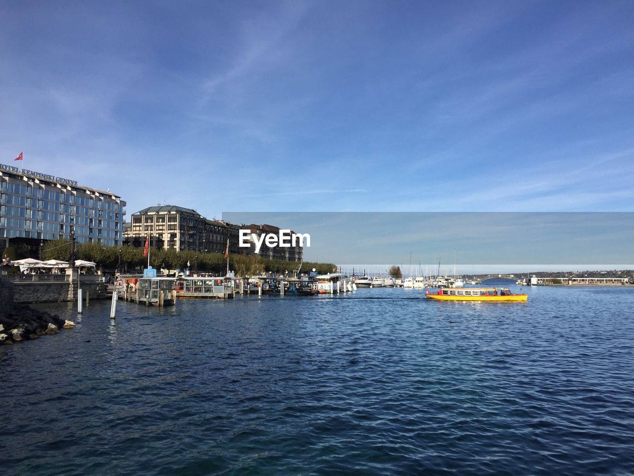 SCENIC VIEW OF SEA AGAINST BUILDINGS IN CITY