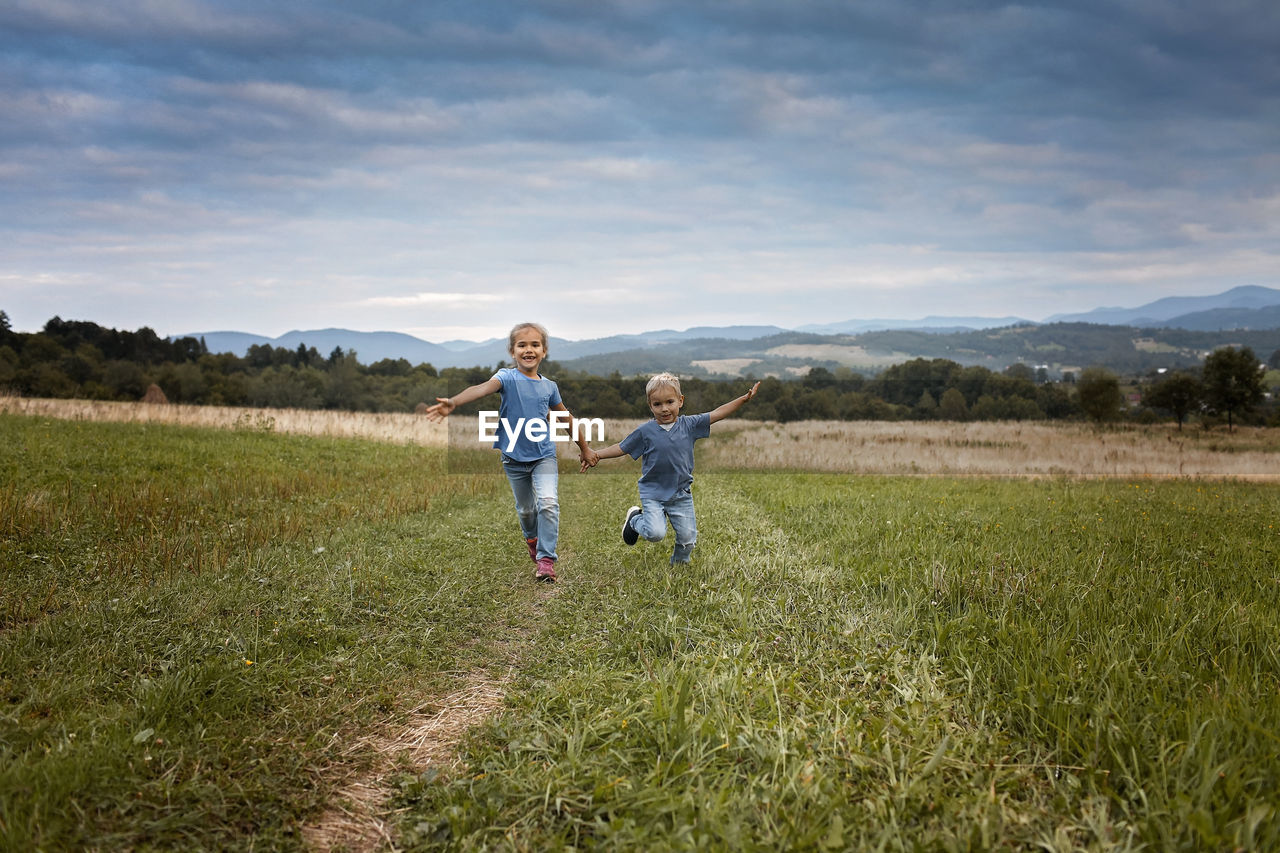 FULL LENGTH OF FATHER AND SON ON FIELD