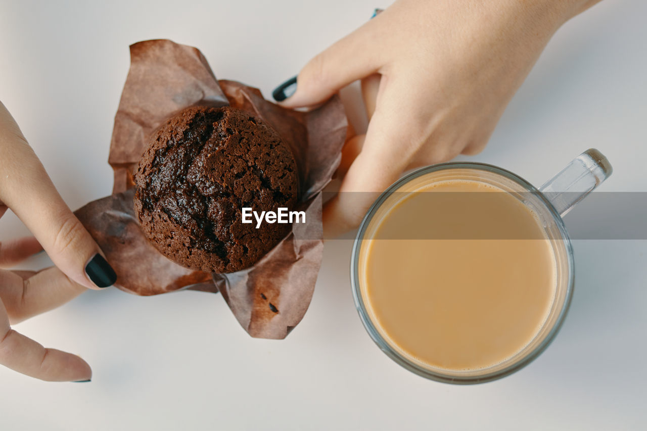 MIDSECTION OF WOMAN HOLDING ICE CREAM WITH SPOON