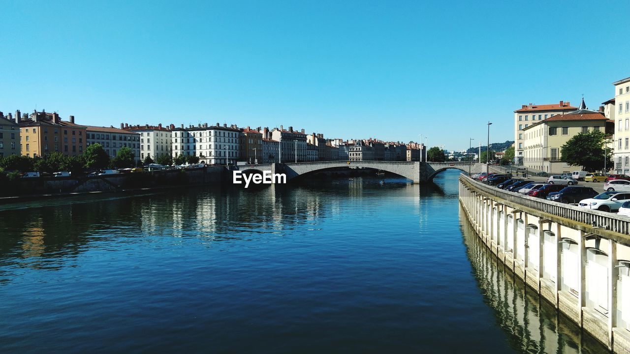 View of buildings on lyon waterfront against clear sky