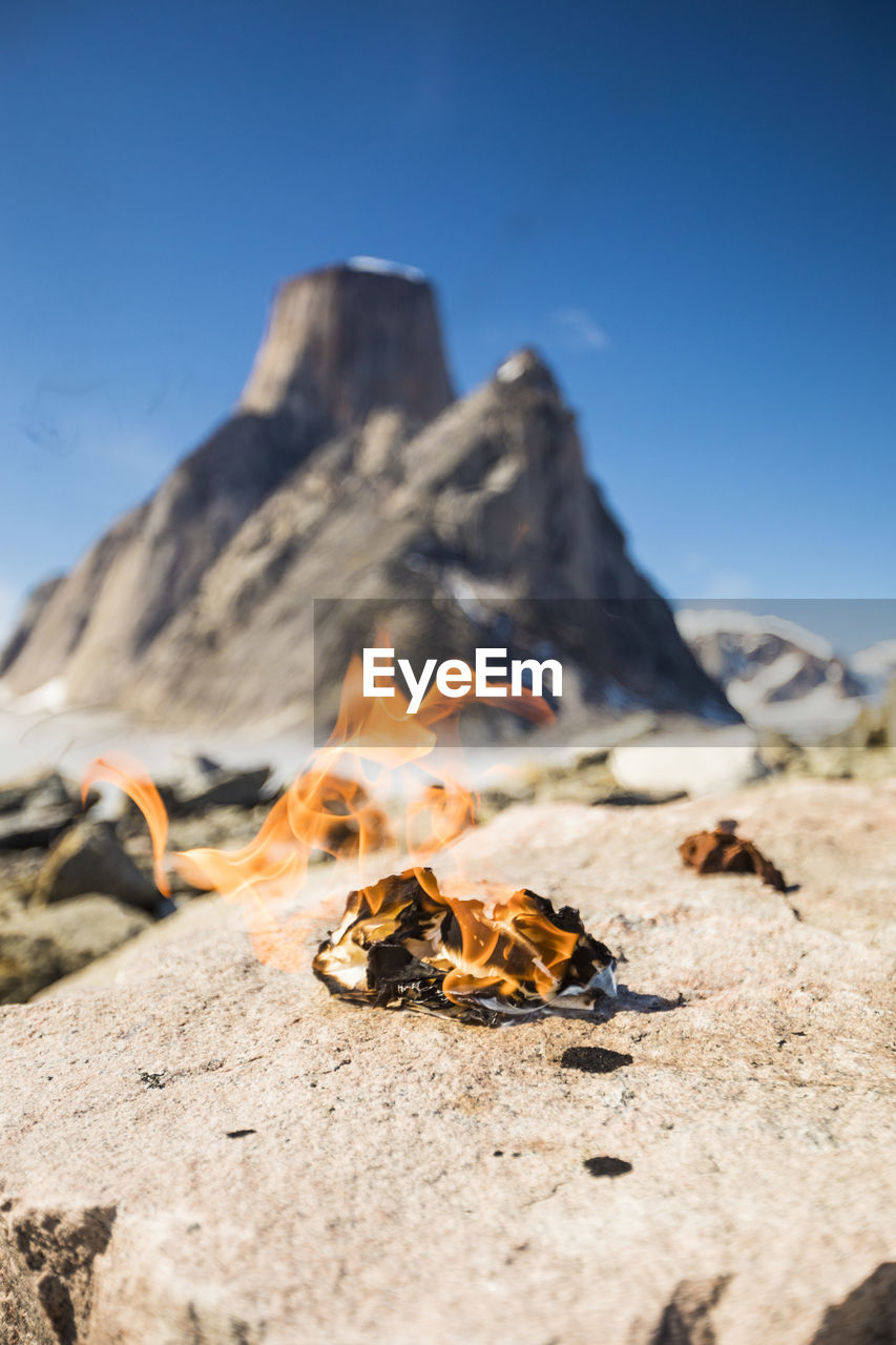 Flaming pile of toilet paper in remote mountains, leave no trace.