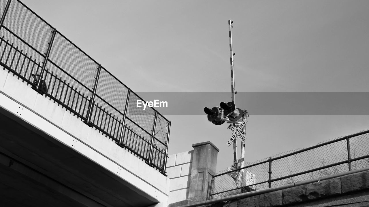 Low angle view of railroad signal against sky