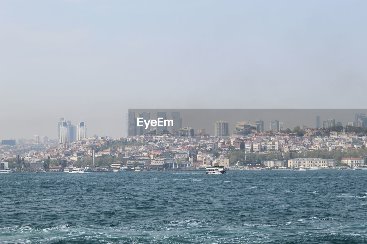 SEA AND BUILDINGS AGAINST CLEAR SKY