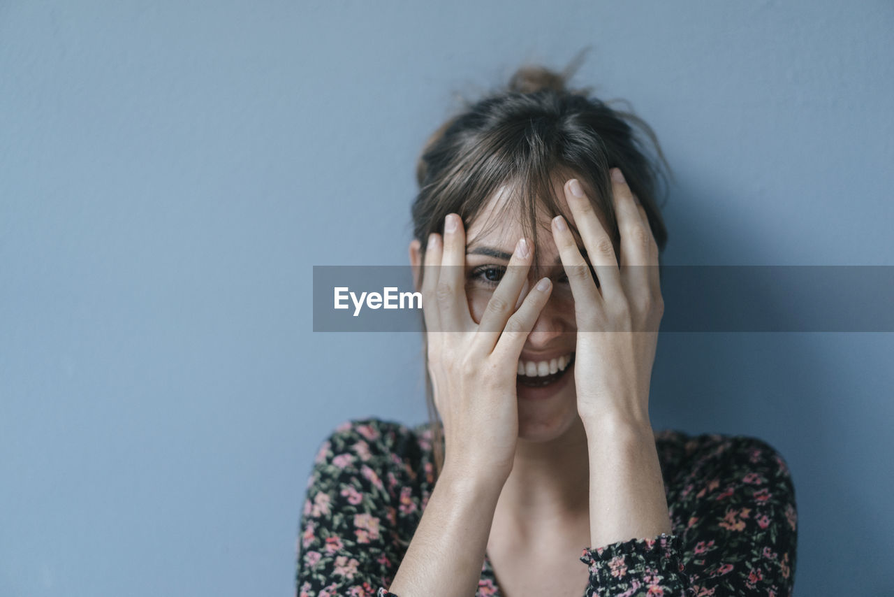 Beautiful woman covering face, portrait