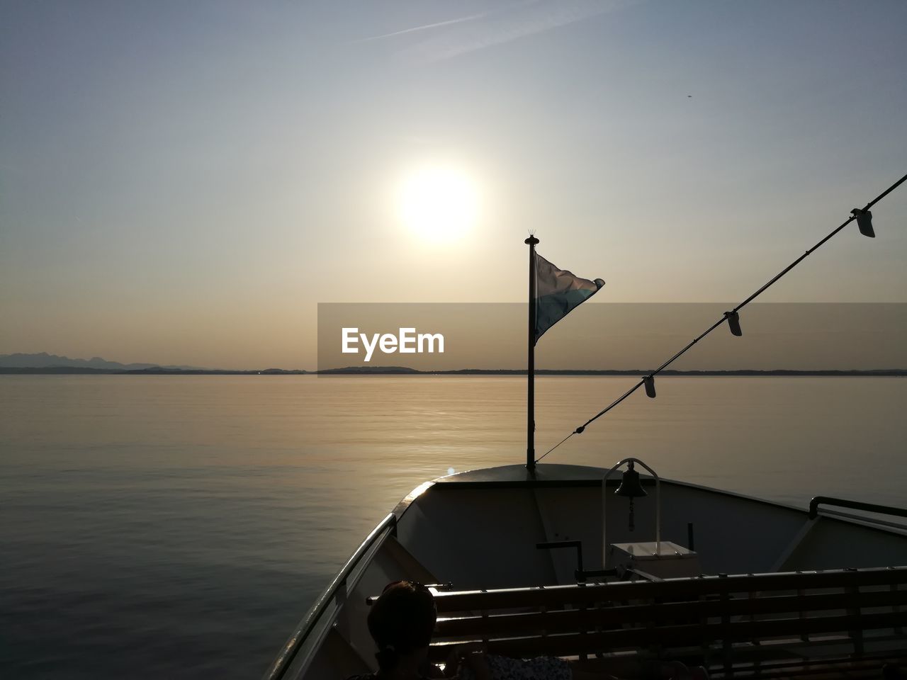 Silhouette of boat sailing in sea at sunset