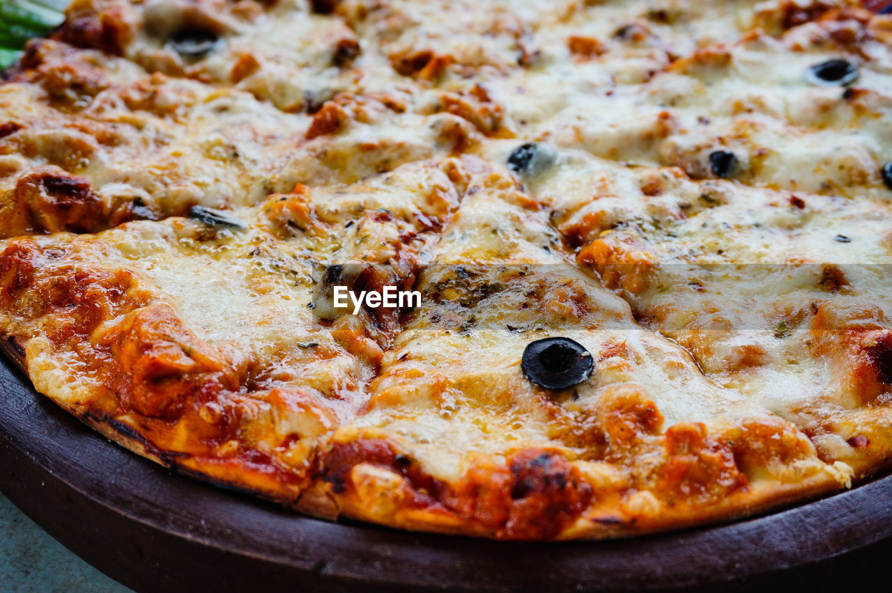 Pizza on wooden rustic background 