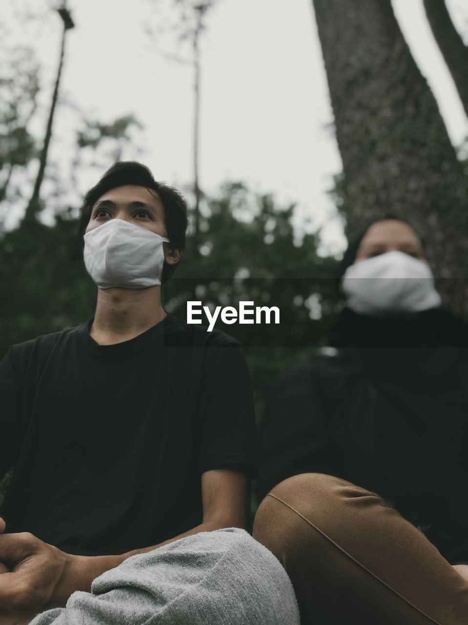 Portrait of a young woman and man sitting outdoors