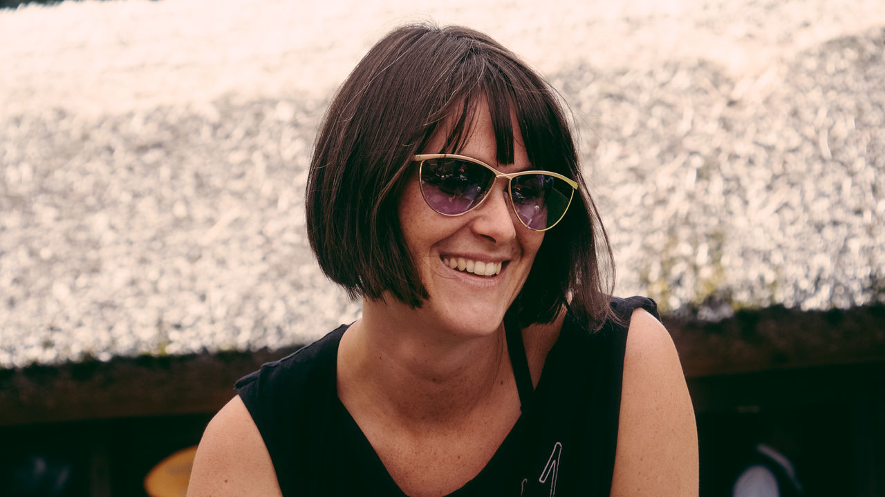 Close-up of young woman wearing sunglasses standing on street