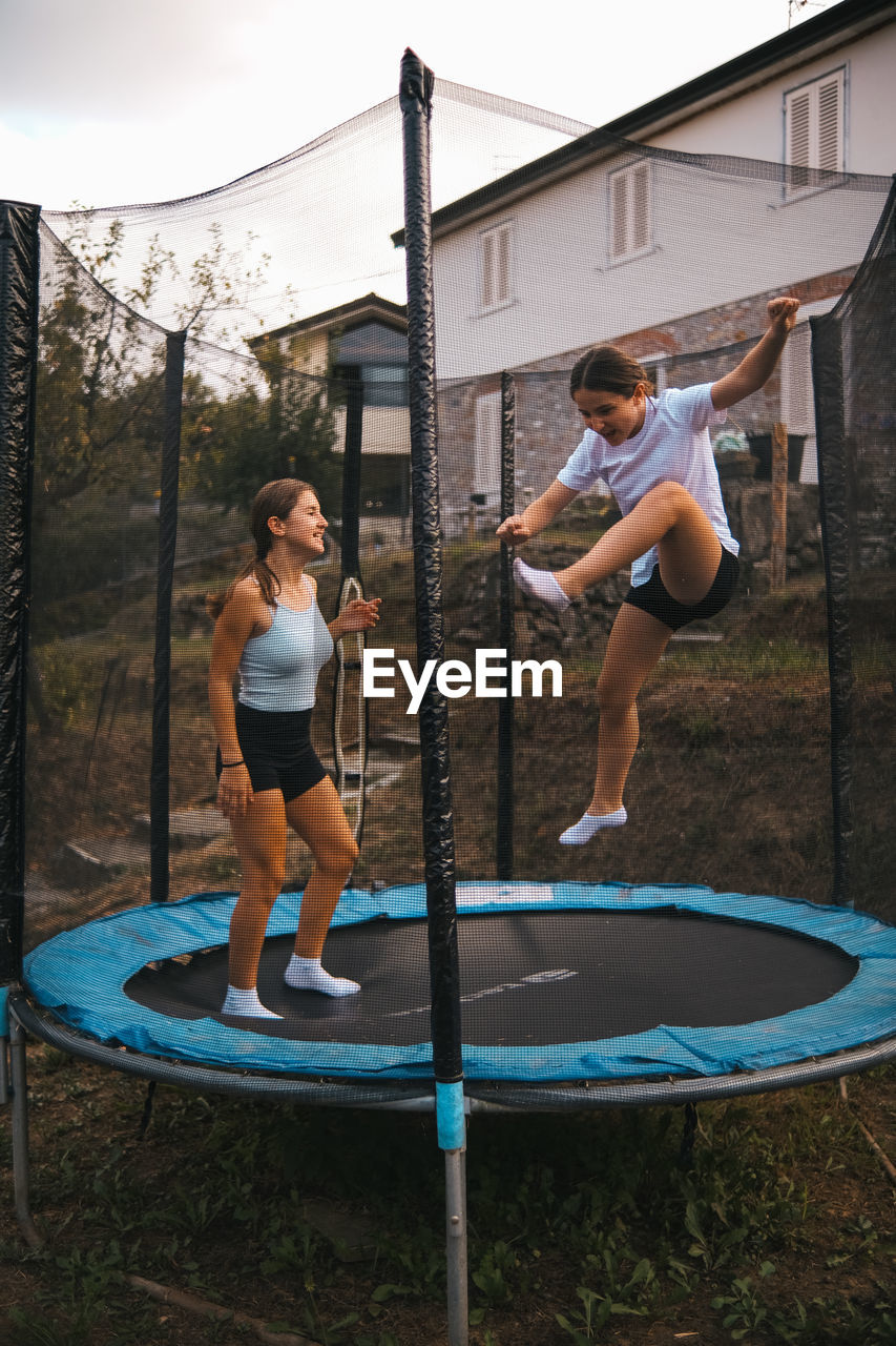 Full length of girls playing and jumping