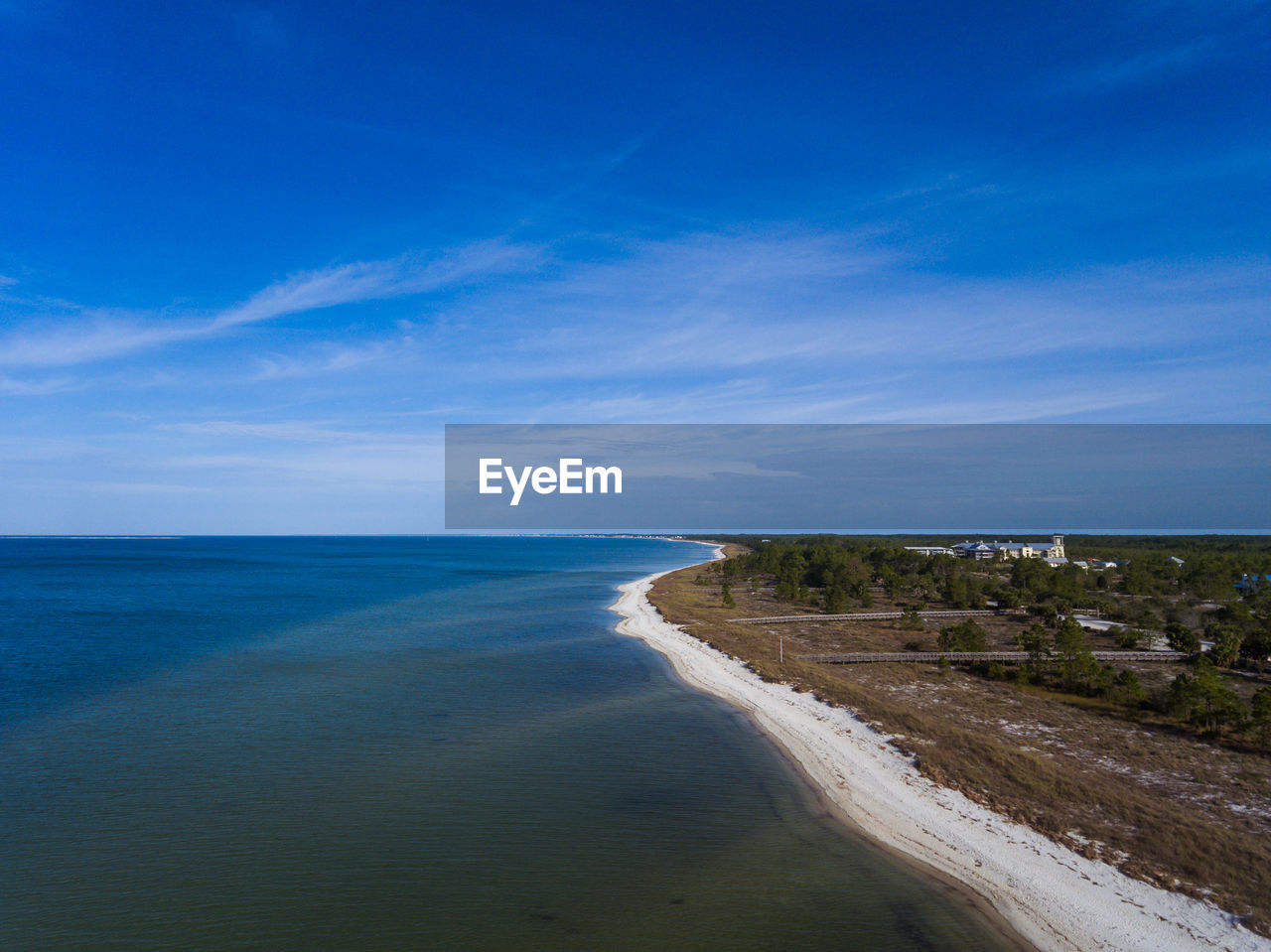 Scenic view of beach against blue sky