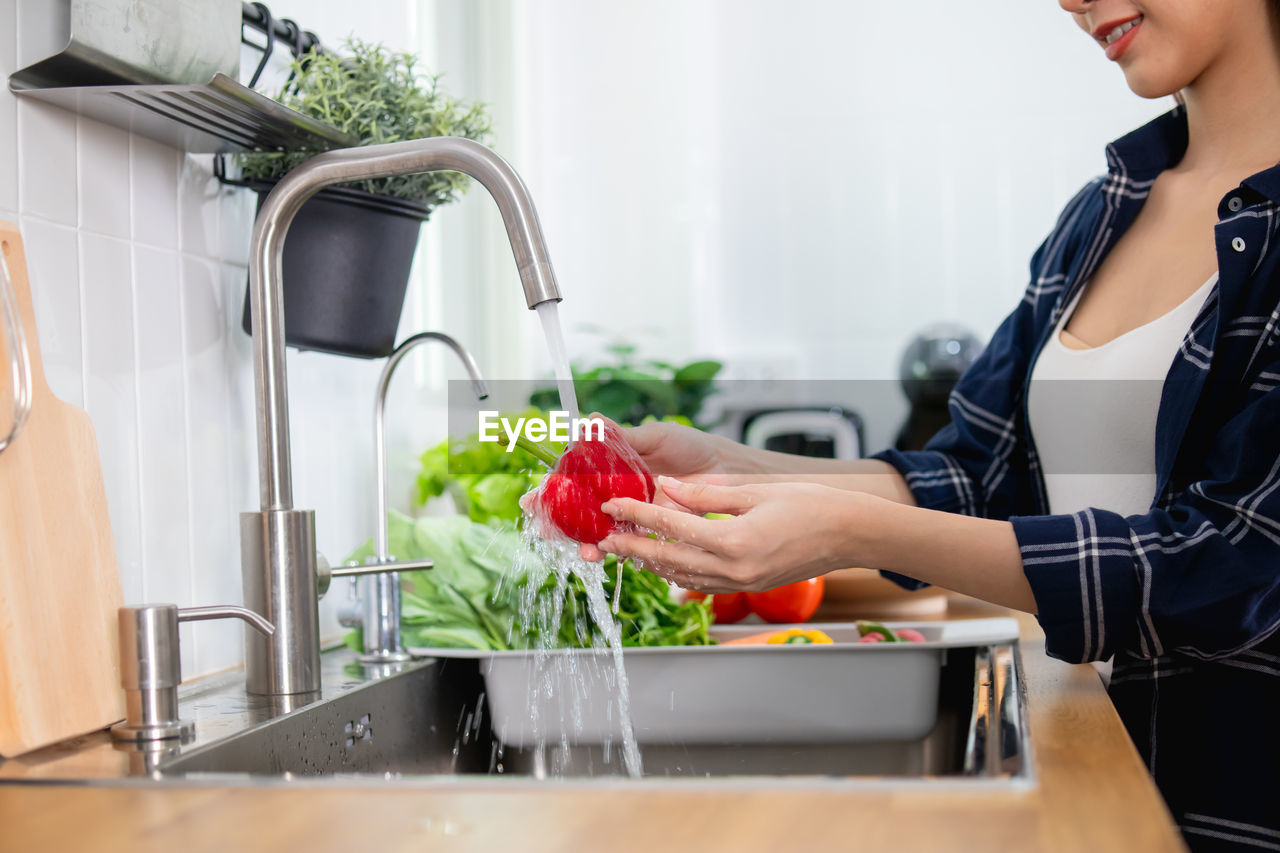 WOMAN PREPARING FOOD AT HOME