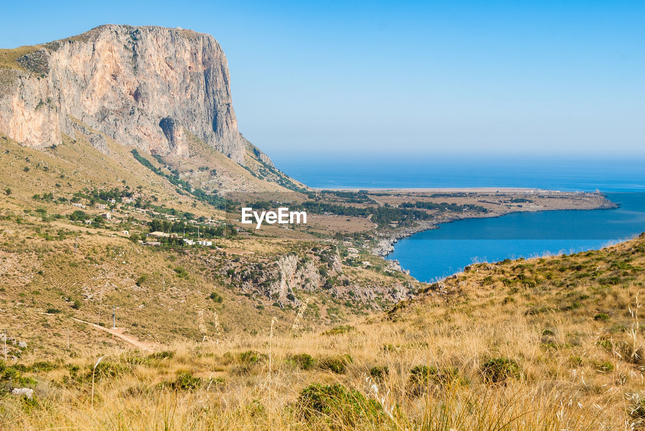 Scenic view of sea and mountains against sky