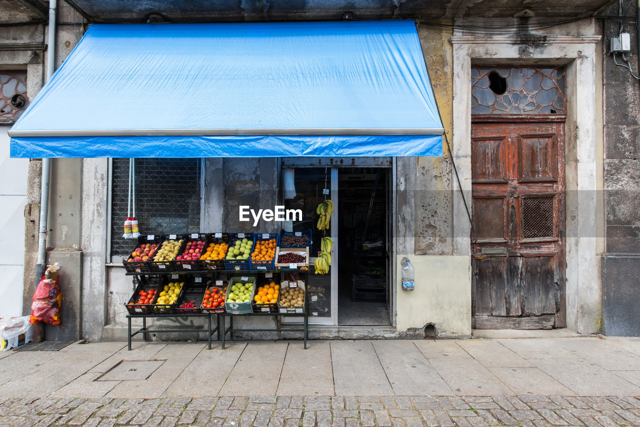 Fruits for sale at market stall outside building