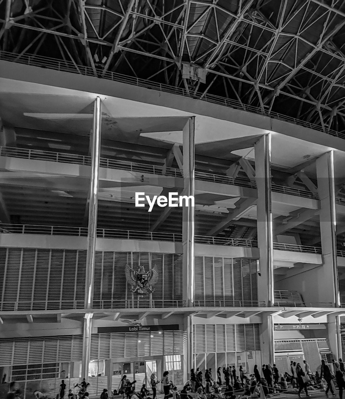 black and white, monochrome, group of people, crowd, architecture, monochrome photography, large group of people, built structure, black, sport venue, men, stadium, adult, women, indoors, lifestyles, urban area, city, ceiling