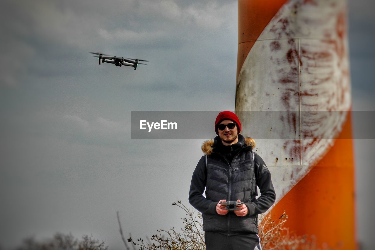 Low angle view of man standing against sky