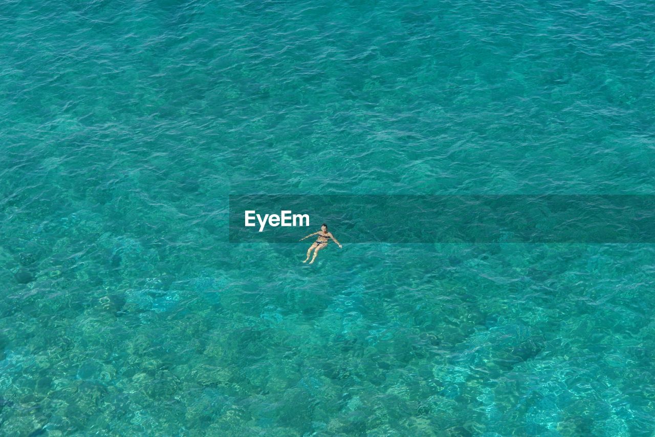 HIGH ANGLE VIEW OF MAN IN WATER