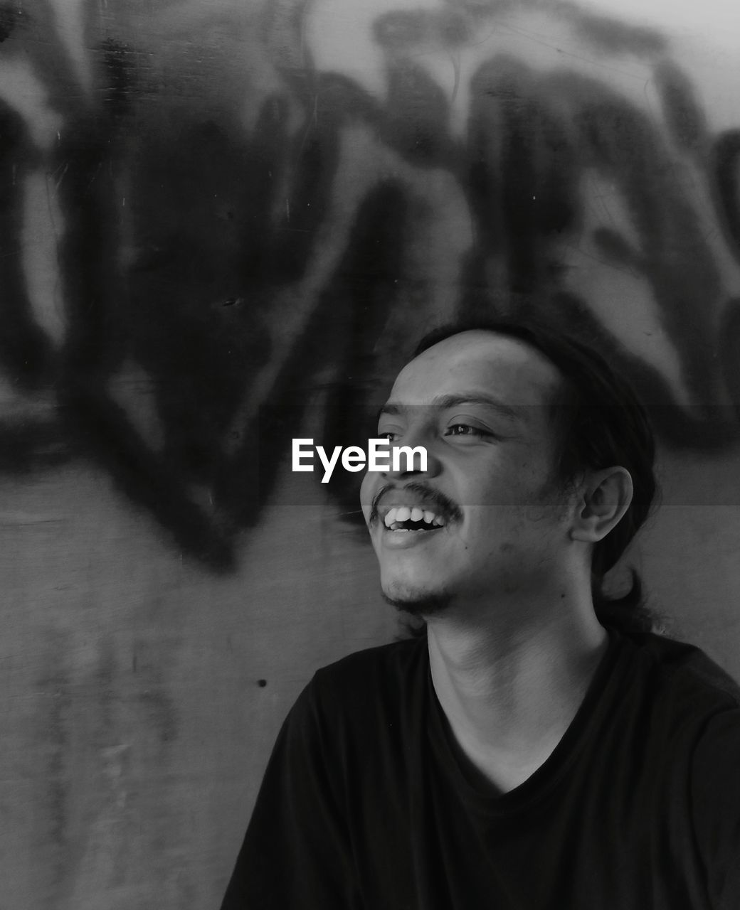 Portrait of smiling young man looking away