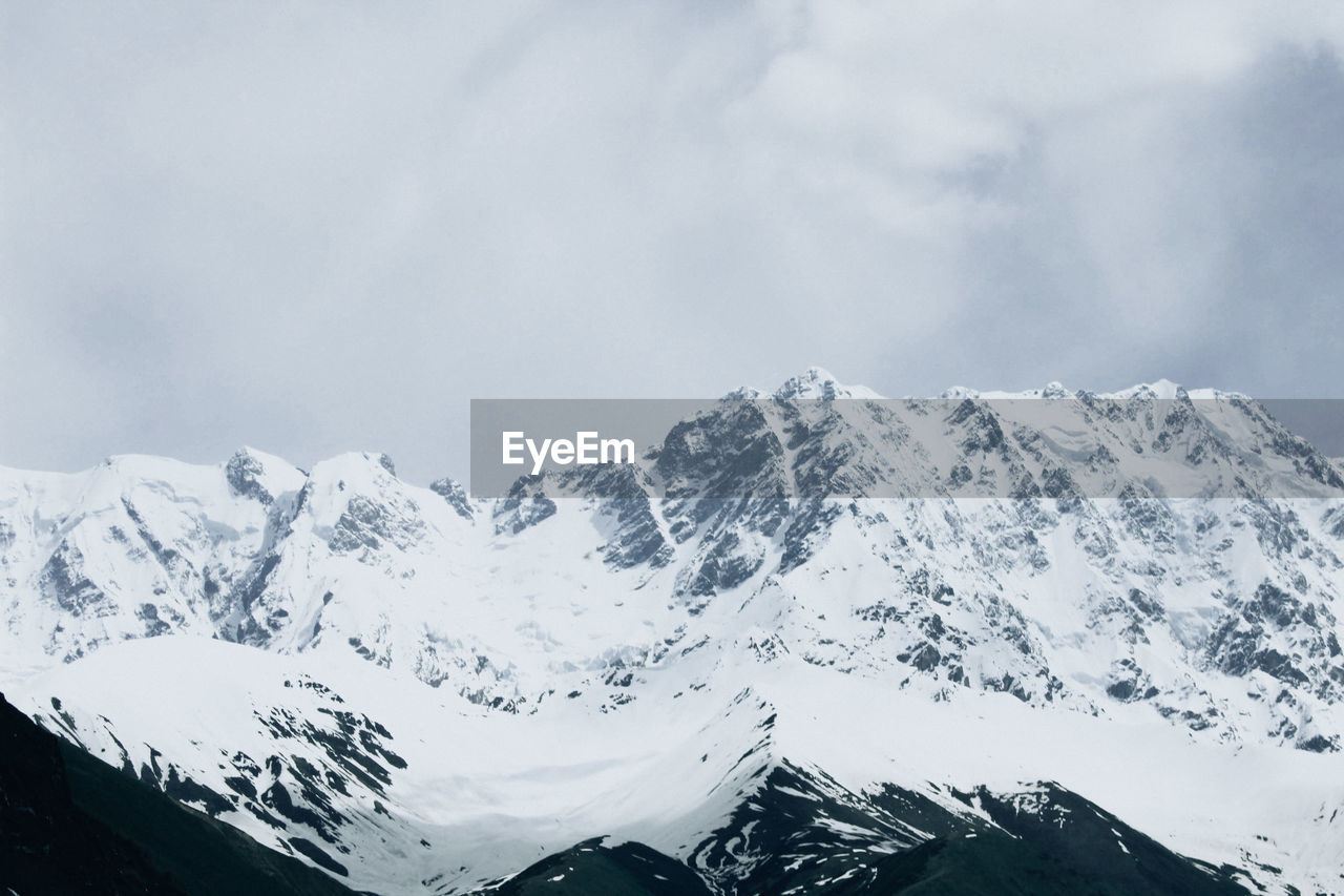 Scenic view of snowcapped mountains against sky. 