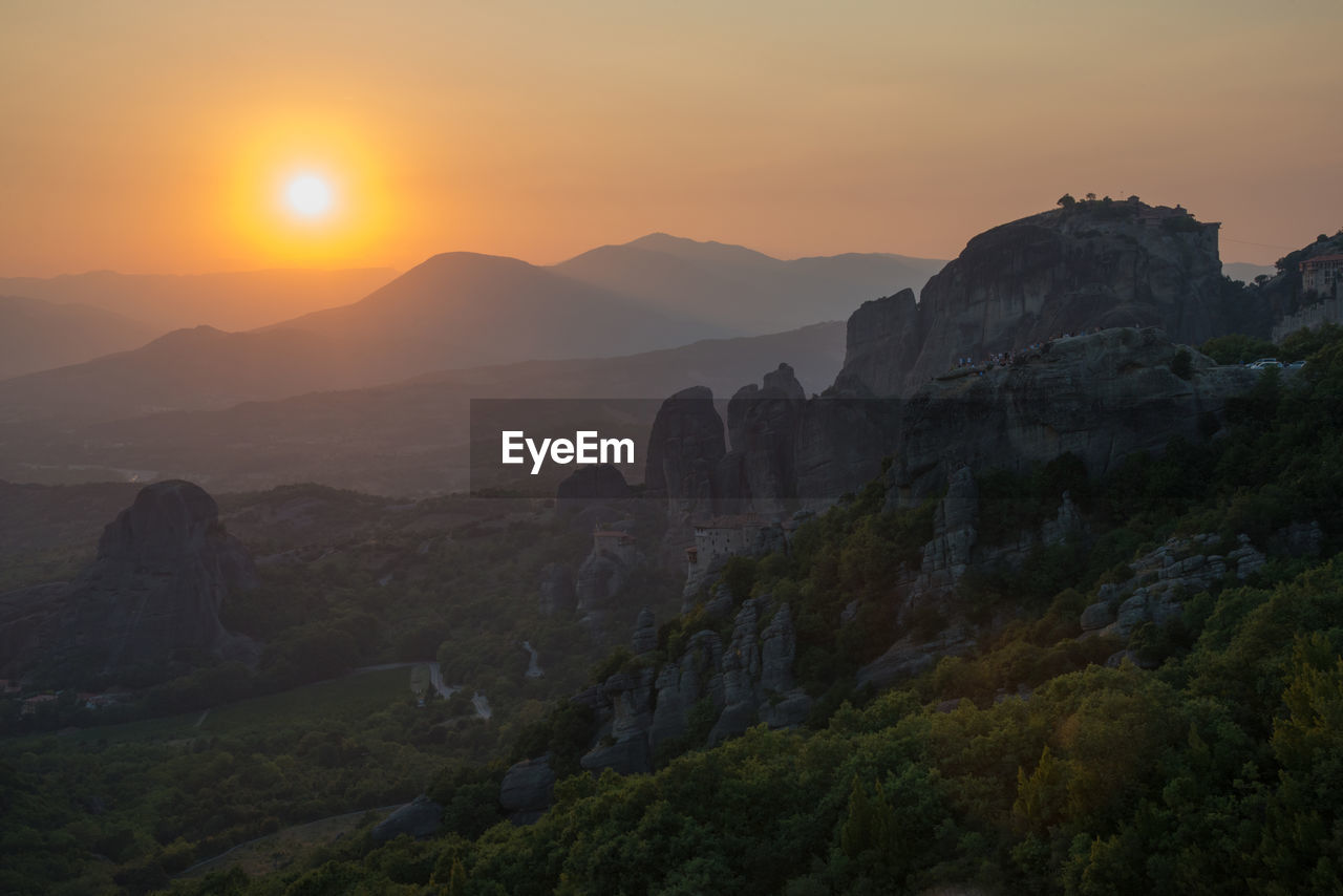 Beautiful view of meteora mountains and monasteries in a summerday at sunset