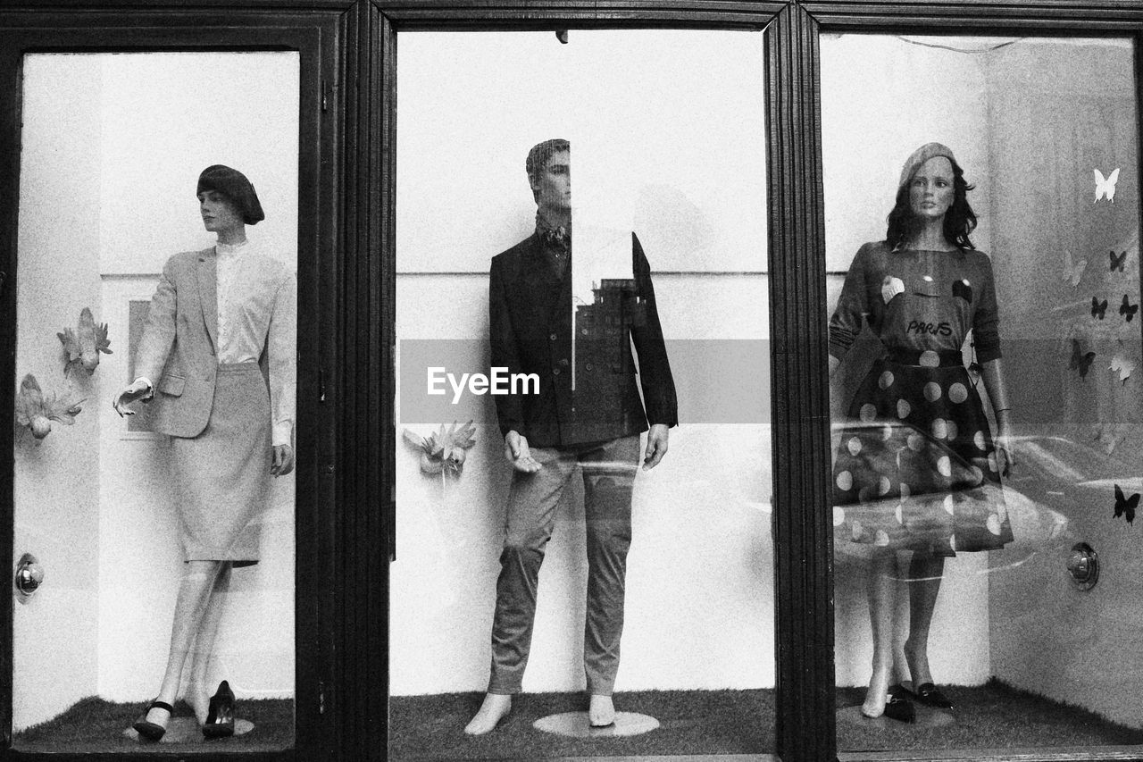 DIGITAL COMPOSITE IMAGE OF PEOPLE STANDING BY WINDOW