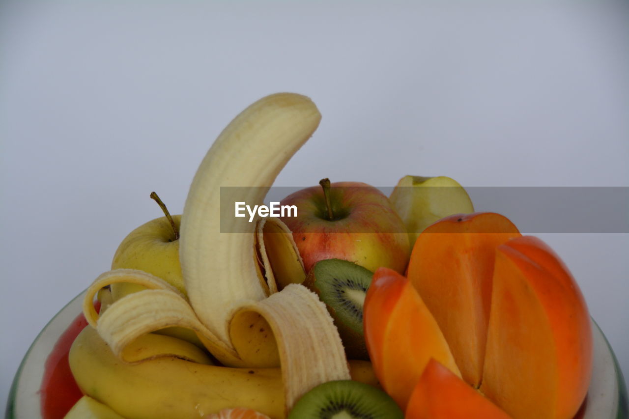 Close-up of various fruit against white background