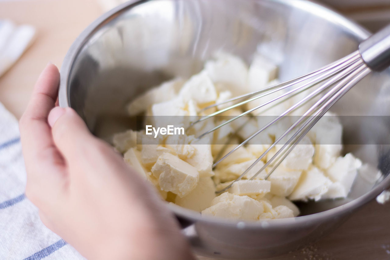 Cropped hand of woman preparing food