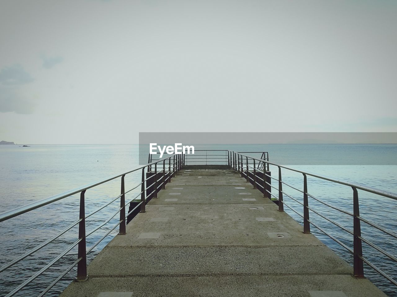 Pier over sea against clear sky