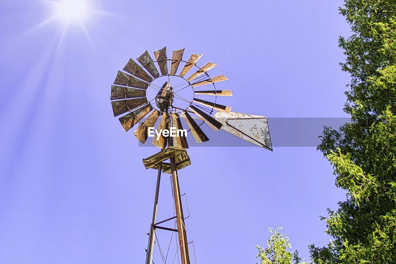 Low angle view of windmill against sky