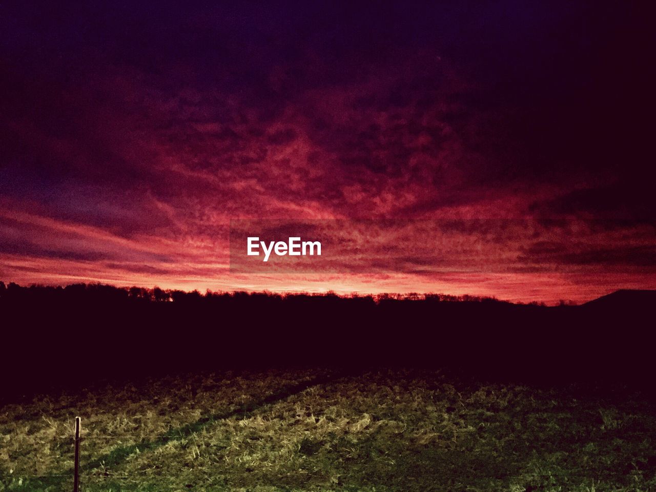 SILHOUETTE FIELD AGAINST SKY DURING SUNSET