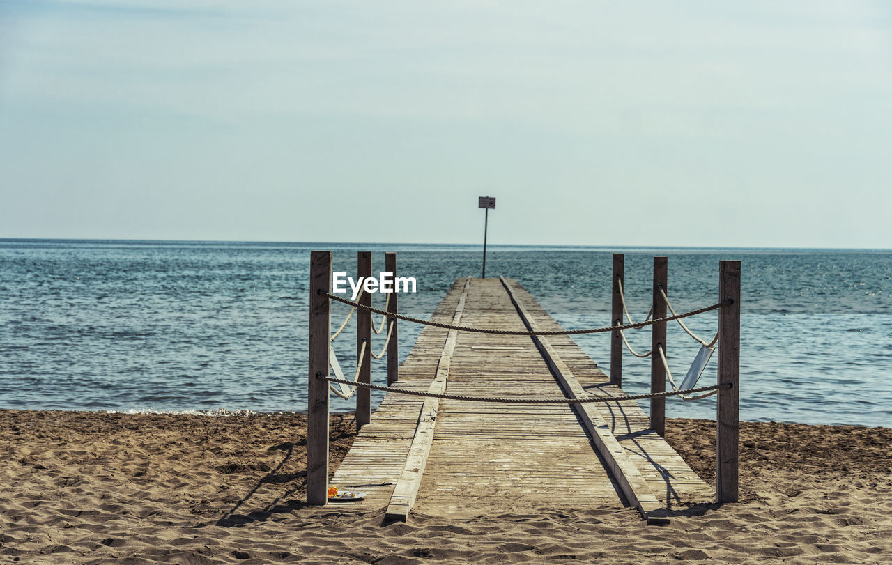 sea, water, sky, horizon over water, beach, horizon, land, ocean, shore, sand, nature, scenics - nature, beauty in nature, tranquility, tranquil scene, body of water, coast, day, no people, pier, outdoors, vacation, idyllic, wave, walkway, wood, non-urban scene, sunlight, railing, absence, cloud, clear sky