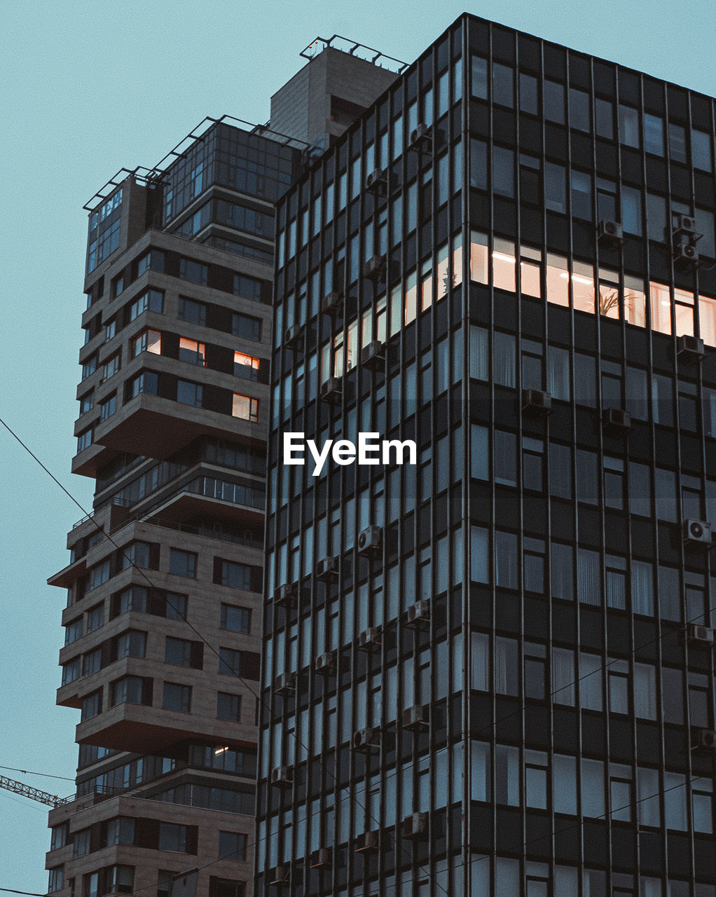 Low angle view of old modern buildings against clear sky