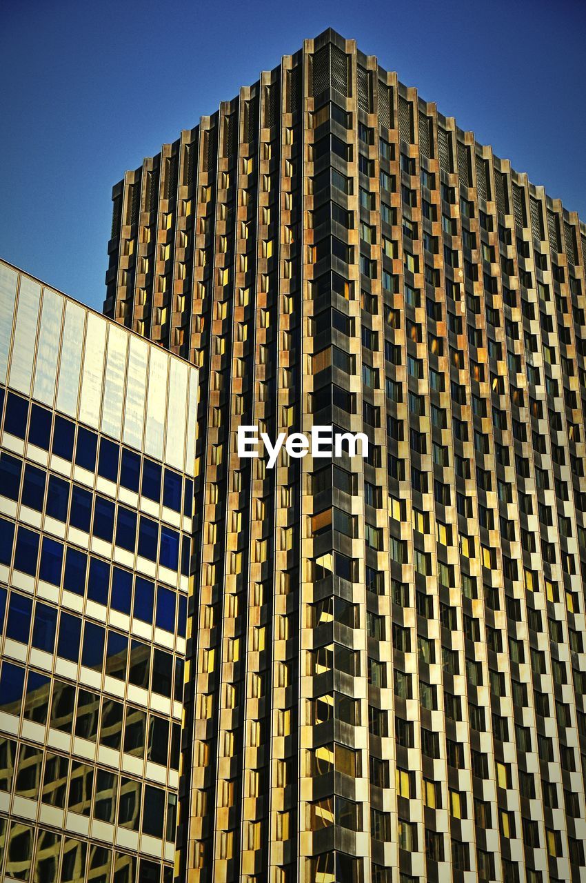 Low angle view of modern building against clear sky