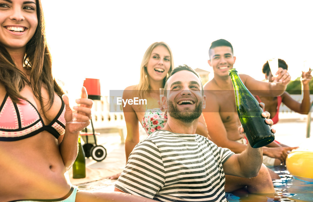 Cheerful of friends enjoying at swimming pool