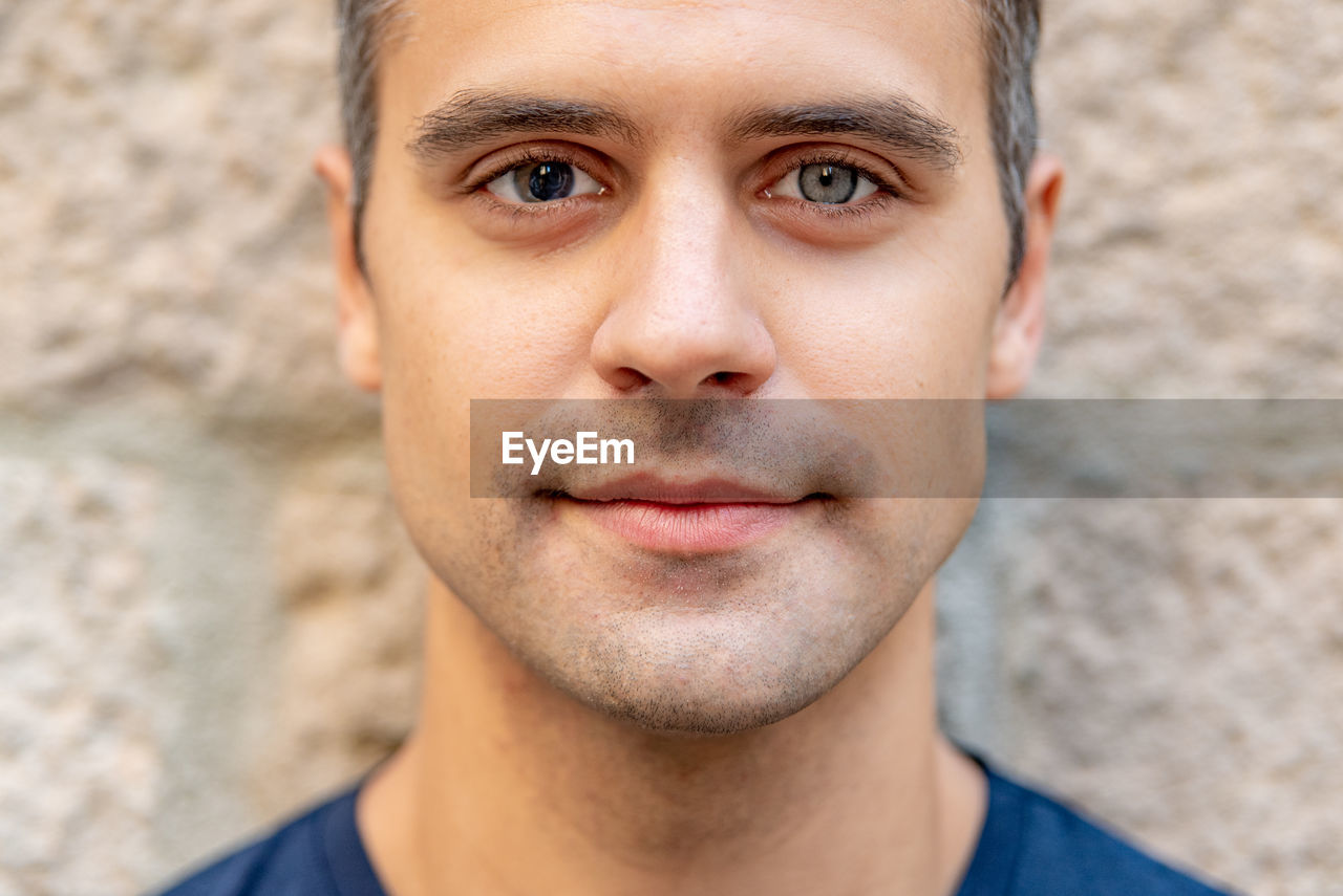 Close up portrait of latin man with heterochromia