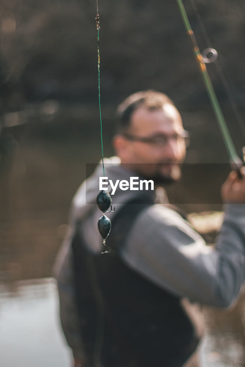 Man fishing in lake at forest