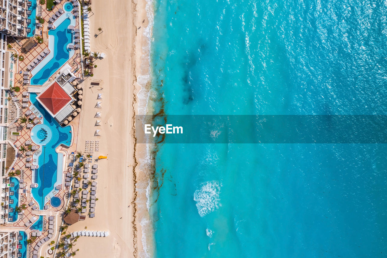 Aerial view of tropical sandy beach with turquoise ocean.